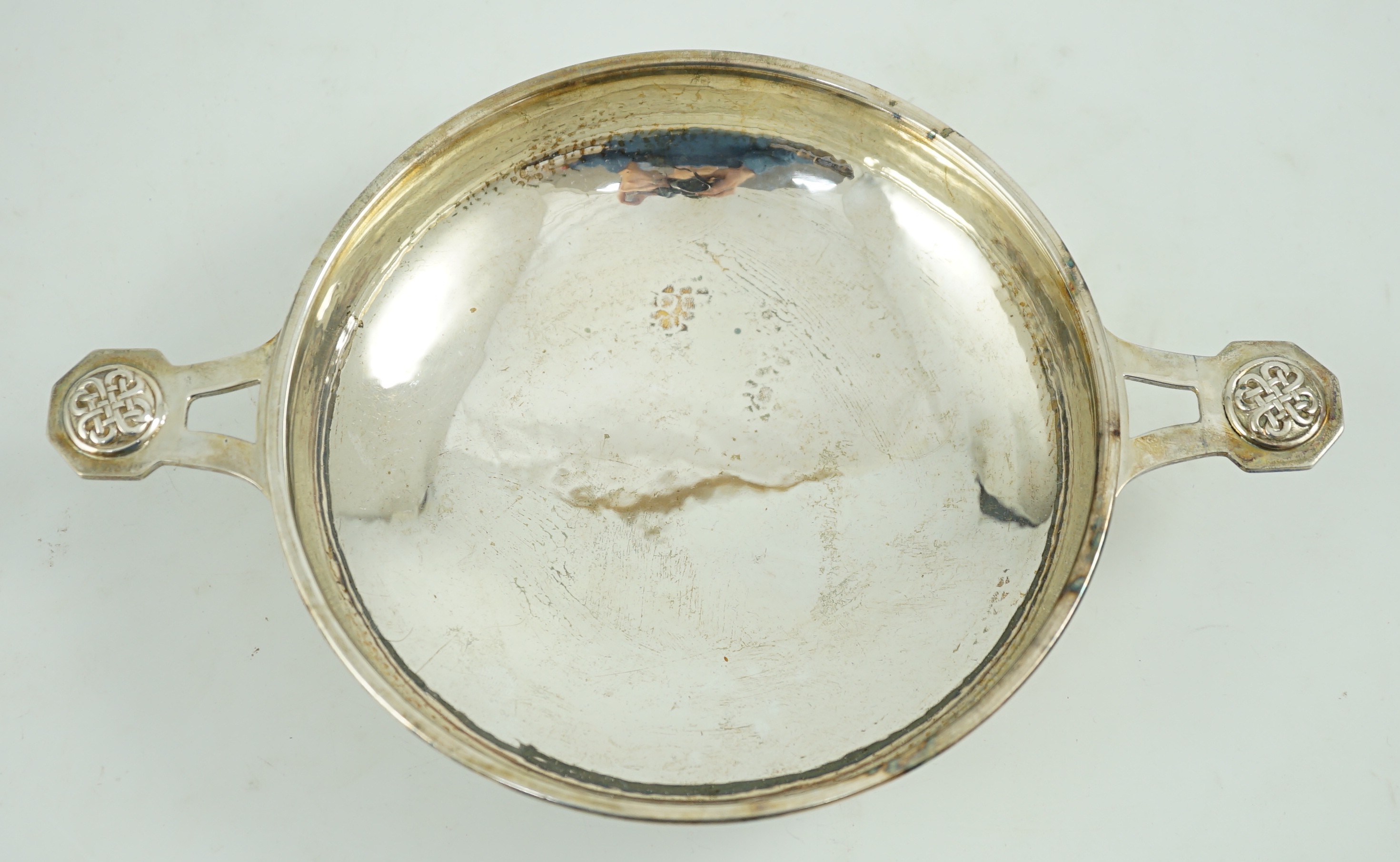 A George V Arts & Crafts planished silver two handled shallow dish, by Albert Edward Jones